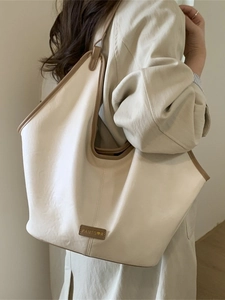 Minimalist cream tote bag with brown piping and large capacity for daily commuting