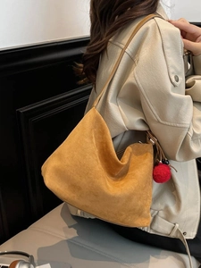 Retro mustard suede hobo shoulder bag with a large capacity and red pompom charm