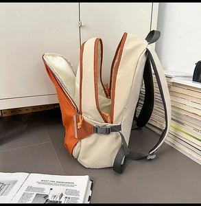 Detail view of large capacity color-block backpack with multi-layer storage compartments