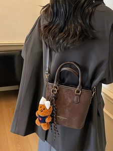 Vintage dark brown crossbody tote bag with bear charm and striped ribbon detail