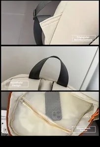 Detail view of reinforced straps, top nylon handle and mesh interior pocket on backpack