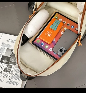 Detail of canvas backpack interior showing spacious compartments for tablet and power bank