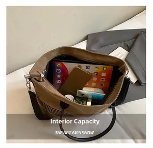 Macro shot showing internal capacity of the brown canvas tote bag with a tablet and phone