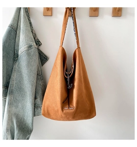 Close-up of caramel suede tote with our cave label and floral lining detail