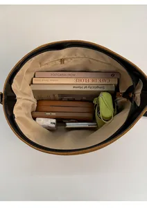 Top view showing the spacious interior of the brown tote bag with zipper and daily items