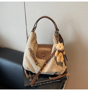 Close-up of leopard print tote bag with suede texture and a cute plush bear charm