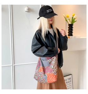Bohemian patchwork tote bag with leopard and floral prints styled on a shoulder
