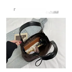 Top-down macro view of spacious interior storage for brown tote bag with essentials