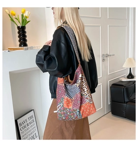 Detail view of large patchwork tote bag featuring leopard and floral print patterns