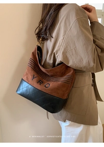 Detail of crossbody bucket bag with brown frosted material and diamond lattice leather