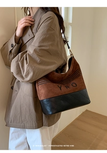 Brown suede and black quilted leather tote bag with YRO logo shown on a model