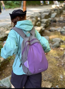Detail of a purple and grey outdoor backpack with waterproof nylon fabric and buckle