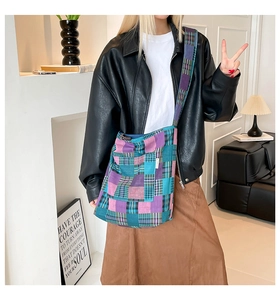 Detail of checkered canvas tote bag with purple and teal plaid pattern and wide strap