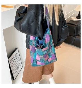Casual colorful patchwork canvas tote bag shown worn on shoulder in a cozy indoor setting