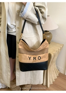 Detail showing the mixed suede texture and quilted leather finish of the crossbody tote bag