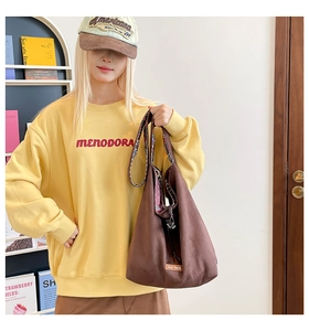 Brown tote bag detail with floral lining and drawstring closure in a lifestyle setting