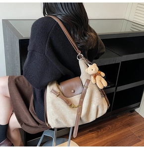 Detail of vintage canvas leopard tote bag with leather flap and plush bear charm