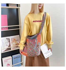 Detailed close-up of ethnic patchwork tote bag with paisley and floral cotton patterns