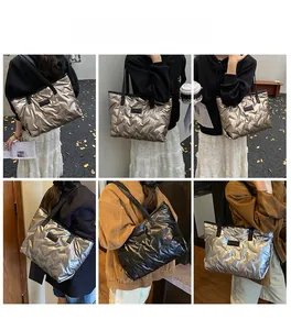 Close-up of metallic quilted tote bags in champagne, silver, and black colors