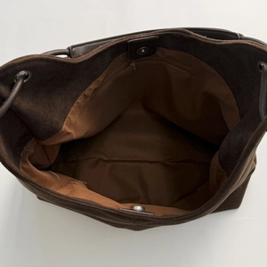 Top view of brown suede tote bag featuring magnetic closure and interior zip pocket