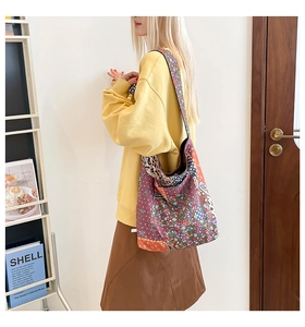Detailed view of bohemian patchwork tote bag with floral and leopard prints worn by model