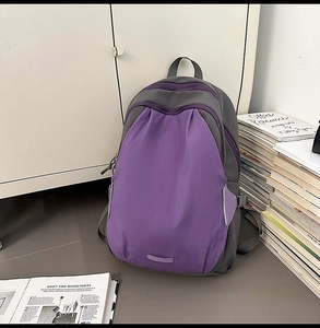Detail of grey and purple contrast backpack with side buckle and adjustable straps