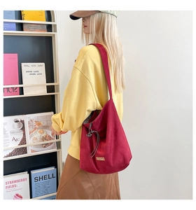Burgundy oversized tote bag featuring vintage suede texture and functional side drawstring detail