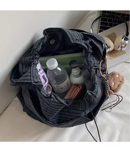 Internal view showing large storage capacity of a black plaid nylon bucket bag