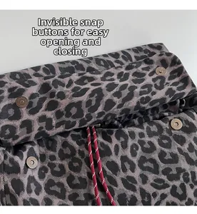 Detail view of leopard print backpack with hidden magnetic snap and red drawstrings