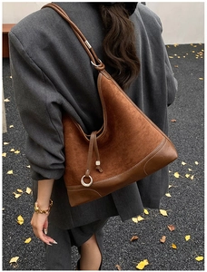 Brown frosted leather Hobo bag shown on shoulder with oversized grey blazer street style