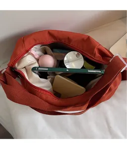 Interior view of the spacious canvas crossbody bag showing high storage capacity for tablet