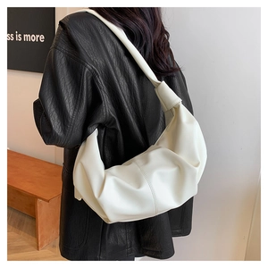Detailed back view of a white ruched crescent bag on a model wearing a black jacket