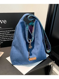 Blue suede drawstring tote bag with adjustable shoulder strap and our fave leather label