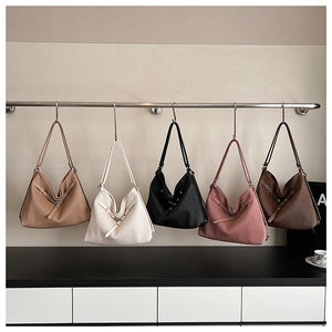 Detail showing five colors of pleated tote bags with slim shoulder straps and buckles