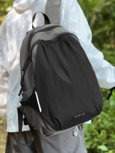Outdoor color-block backpack in grey and black with multi-layer zippers and adjustable buckles