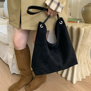 Detail of black suede tote bag with minimalist silver ring and large capacity shoulder strap
