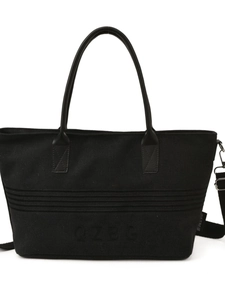 Large black striped canvas tote bag with leather handles and wide shoulder strap for women