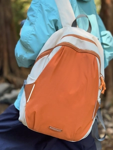 Contrast color outdoor backpack in orange and beige for hiking and travel use