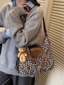 Large leopard print hobo bag with brown leather trim and cute plush bear charm