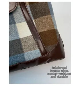 Detail of plaid fabric and leather base with scratch-resistant reinforced stitching
