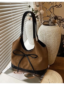Retro brown suede bucket bag with black leather bow detail and shoulder strap for women