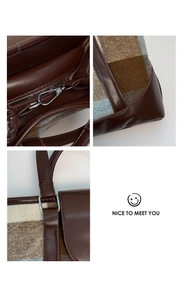 Detail view of the vintage plaid wool bag showing silver hardware and inner zipper pocket