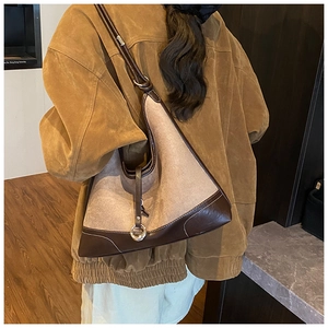 Detail of vintage patchwork tote featuring brown leather, wool felt, and fine contrast stitching