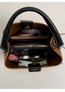 Interior view showing the large capacity and storage compartments of the leopard bucket bag