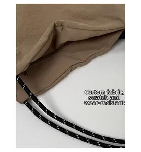 Detailed macro view of scratch-resistant fabric and interior pocket on a large canvas bag