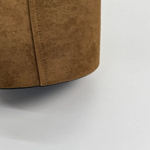 Detailed close-up of brown suede leather texture with premium fine stitching craftsmanship