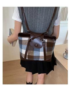 Detailed view of vintage plaid wool tote bag showing leather straps and woven pattern
