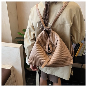 Detail of pleated brown faux leather texture on a versatile retro backpack for women