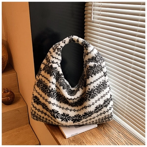 Detailed view of plush snowflake pattern tote bag with thick faux shearling texture