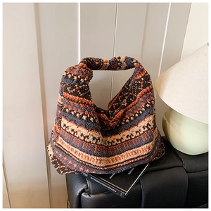 Detailed close-up of plush faux fur tote bag with geometric ethnic patterns and soft texture